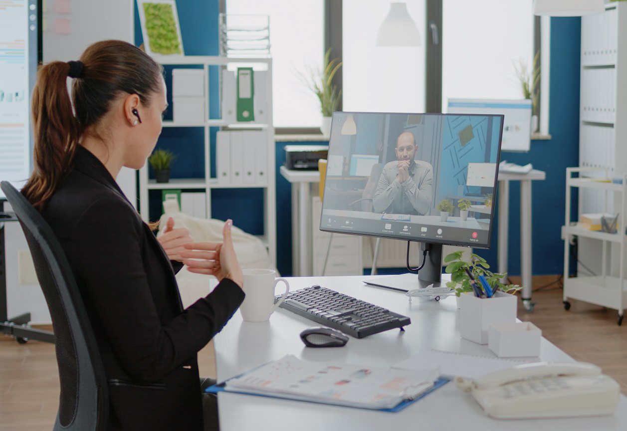 Woman talking to boss on video call communication for marketing strategy in corporate office. Entrepreneur using online conference for business meeting on computer with work manager